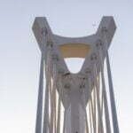 a tall white bridge with a sky in the background