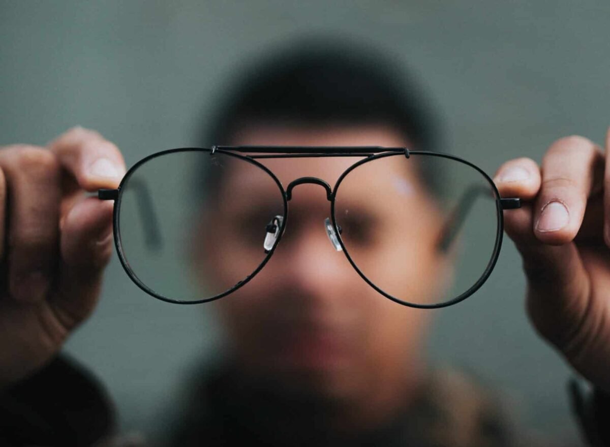 man holding eyeglasses